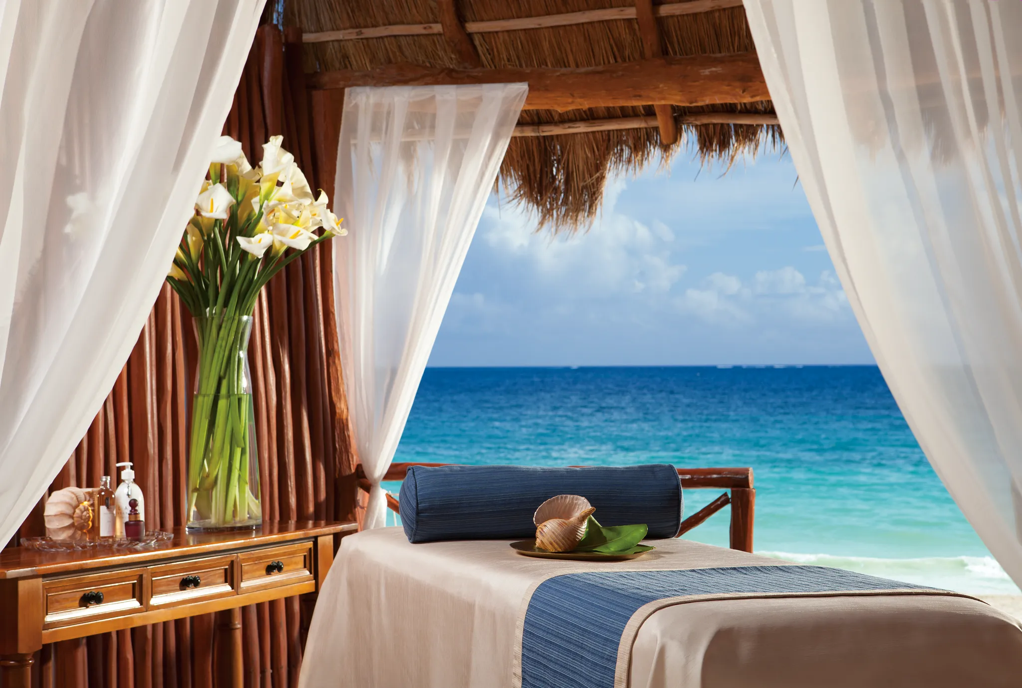 Beachfront massage cabana overlooking the Caribbean Sea at Dreams Sapphire Resort & Spa.