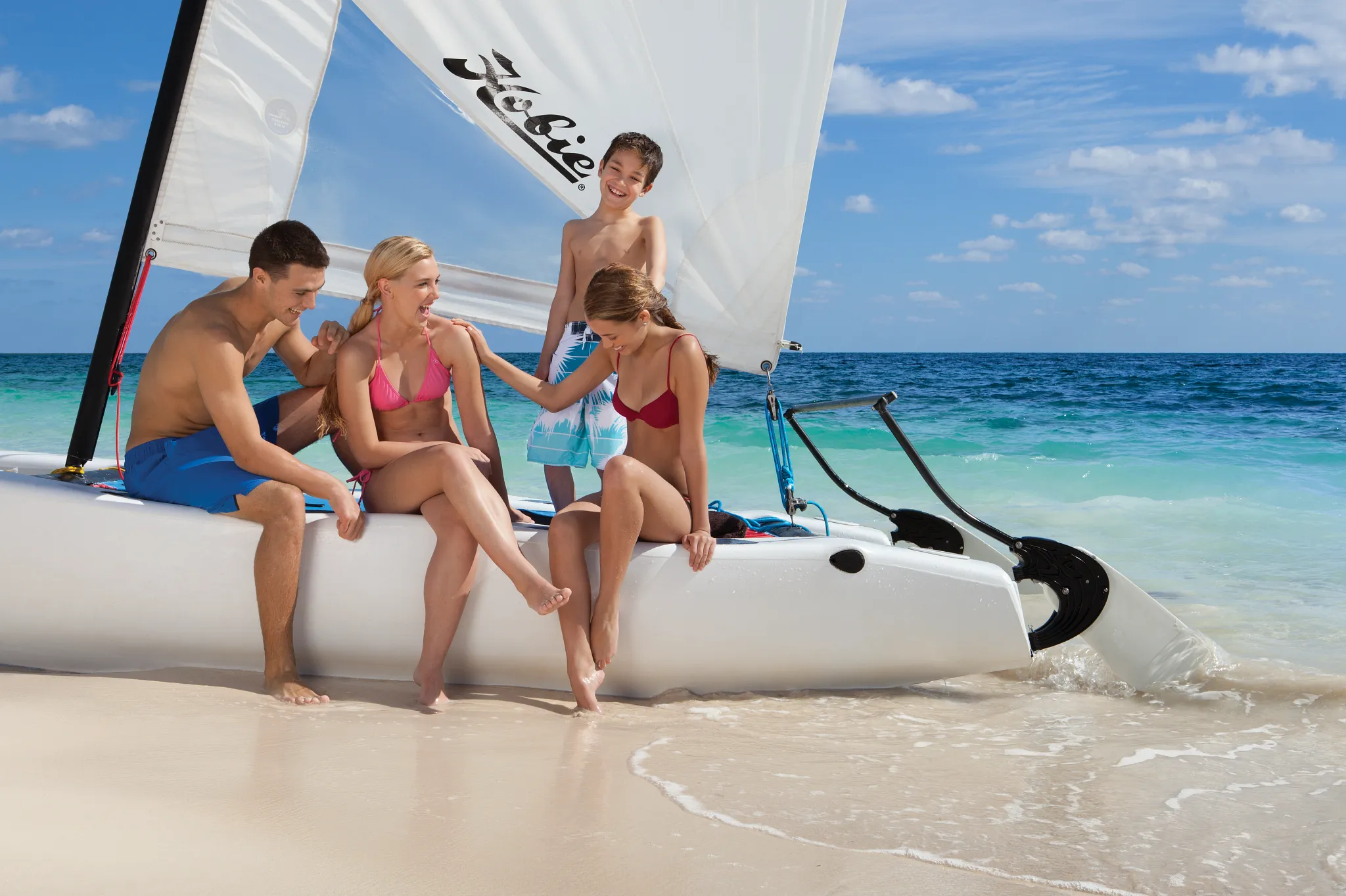 Family enjoying a catamaran sailing adventure on the Caribbean coast near Dreams Sapphire Resort & Spa.