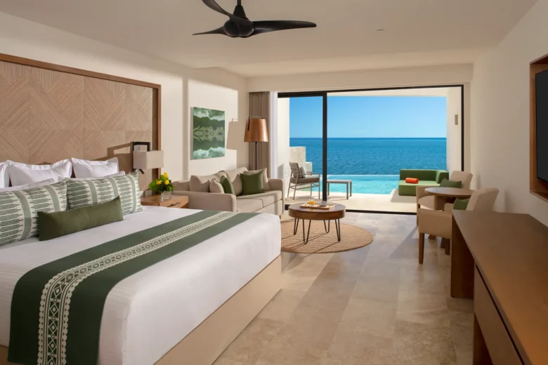 Club Junior Suite Ocean Front Swim Out King with private terrace, semi-private pool access, and Caribbean Sea views at Dreams Sapphire Resort & Spa.