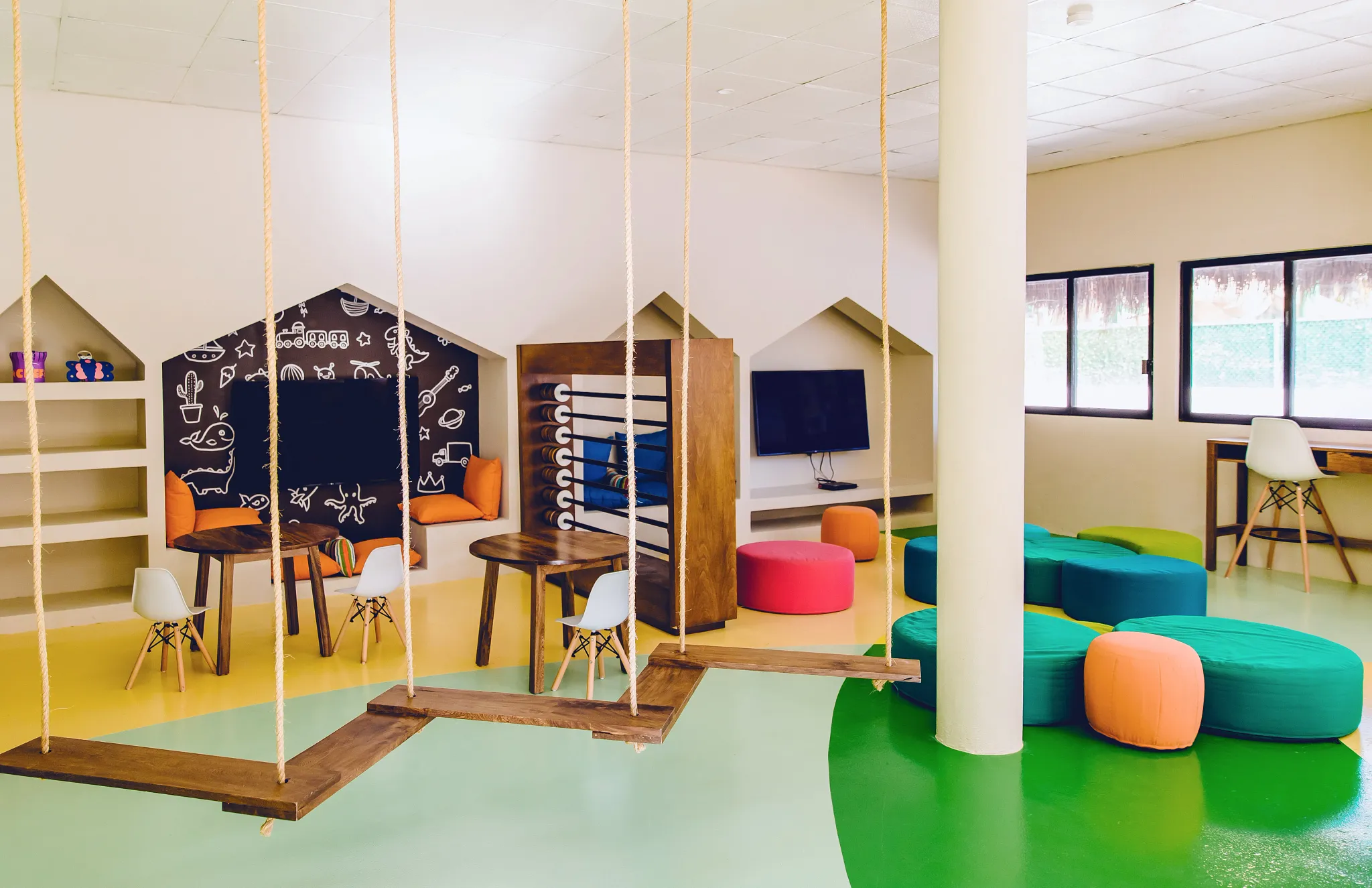 Colorful Explorers Club at Dreams Sapphire Resort & Spa featuring swings, games, and creative spaces designed for children.