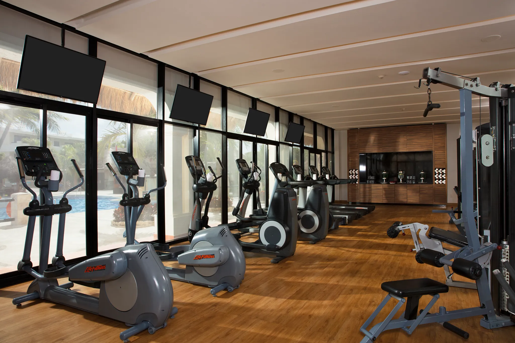 Modern fitness center with cardio and strength-training equipment at Dreams Sapphire Resort & Spa.