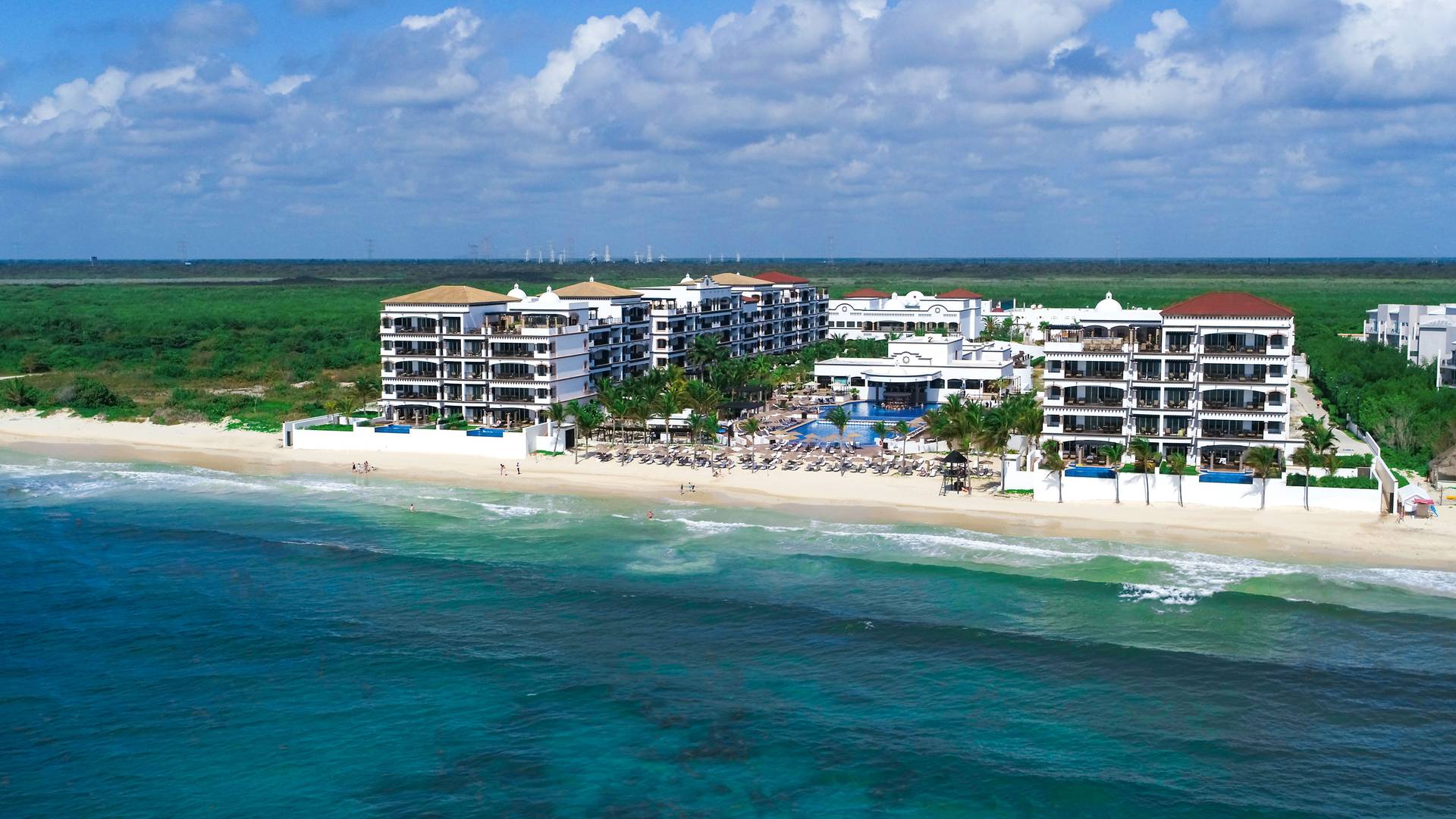 Grand Residences Riviera Cancun luxury beachfront resort with spacious suites, pools, and upscale amenities in Puerto Morelos, Mexico.