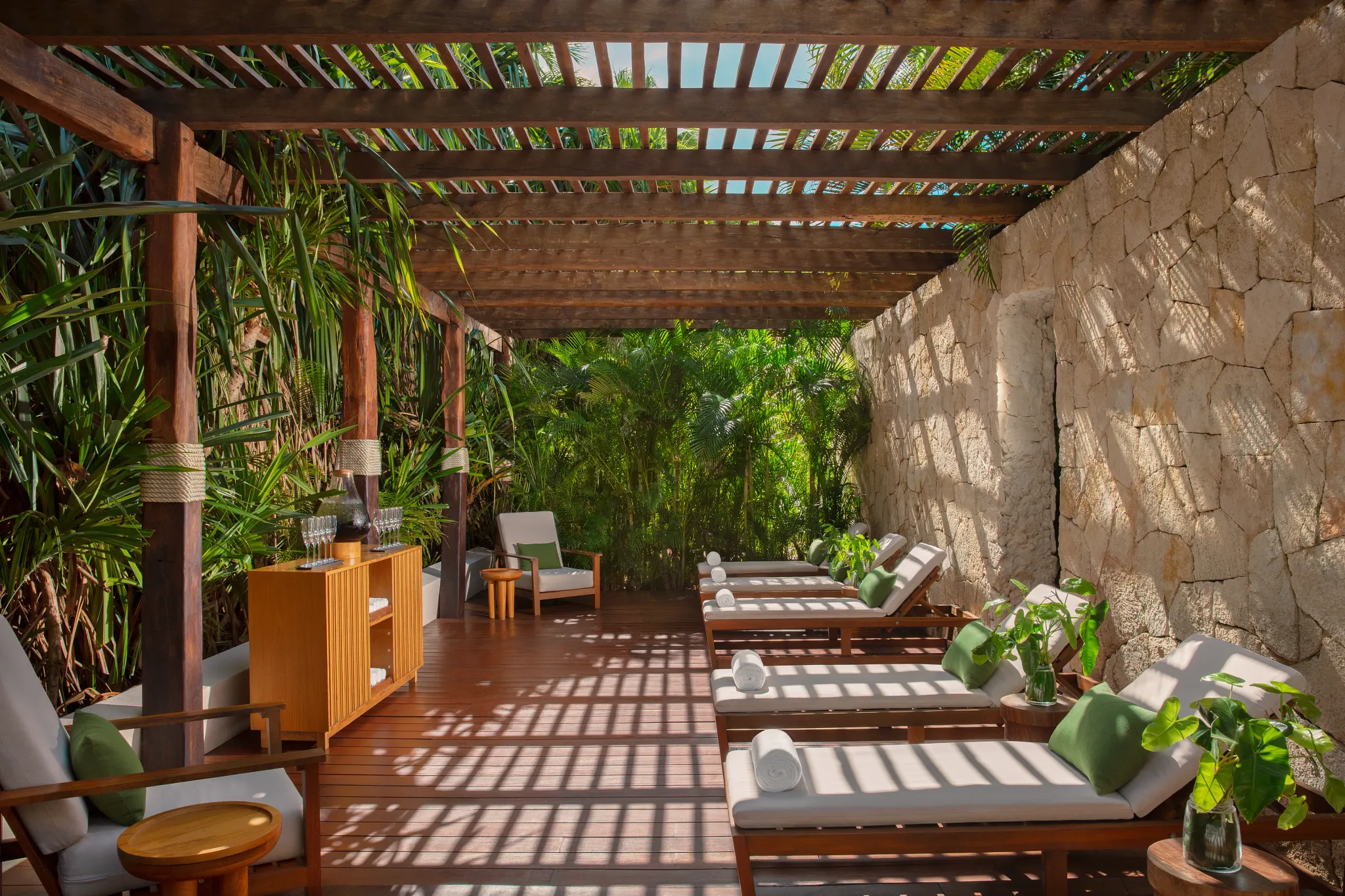 Outdoor spa relaxation deck with lounge chairs surrounded by tropical gardens at Dreams Sapphire Resort & Spa.