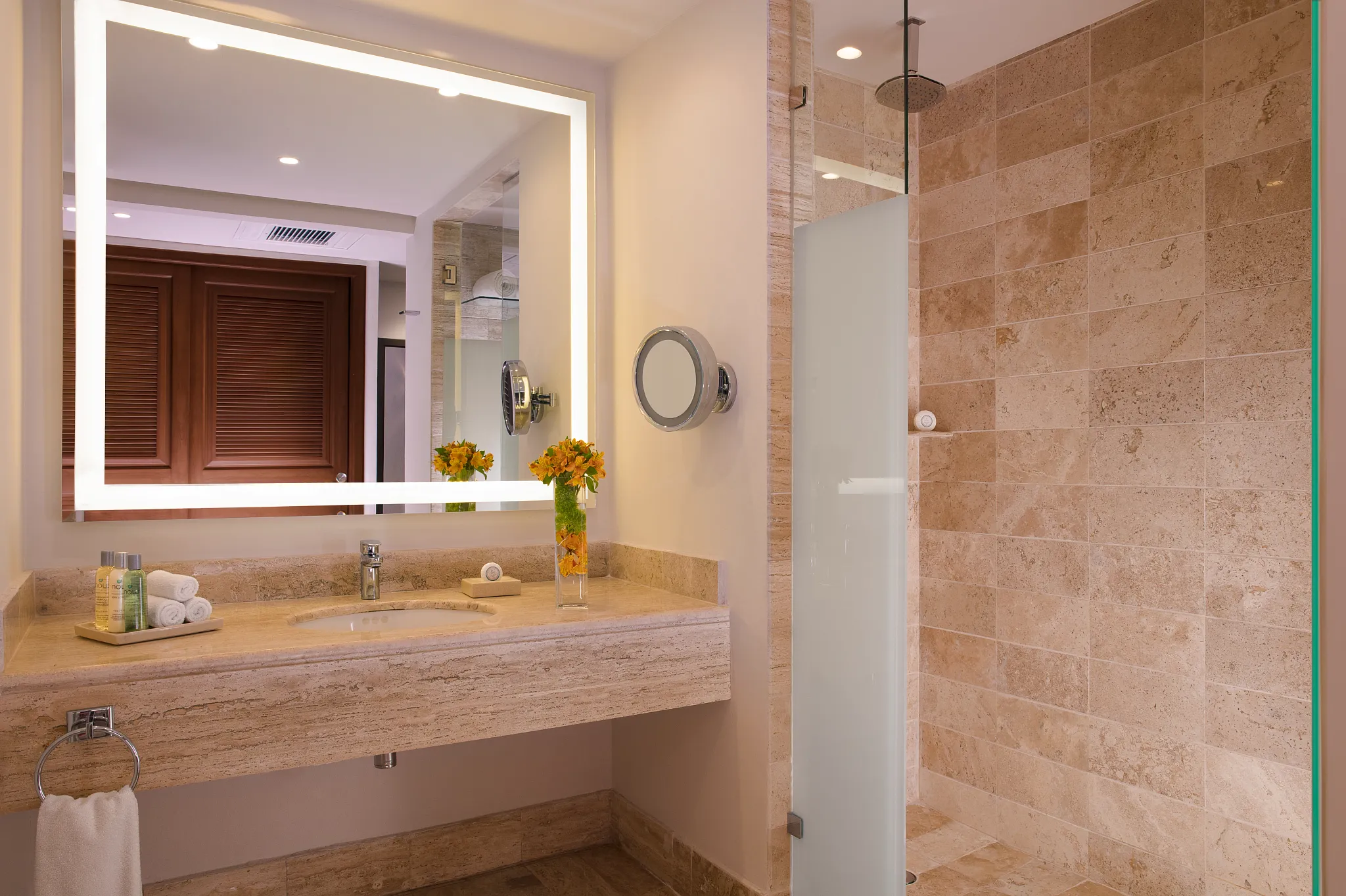 Preferred Club Junior Suite Beach Front Swim Out bathroom with marble vanity and walk-in shower at Dreams Sapphire Resort & Spa.