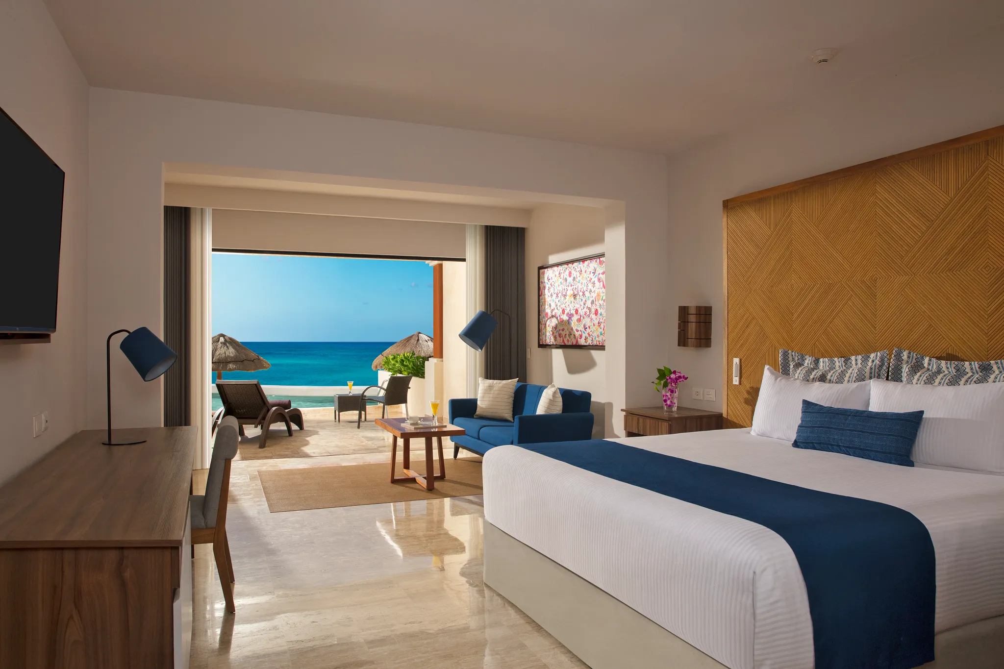 Preferred Club Junior Suite Beach Front Swim Out with king bed, living area, and beachfront terrace at Dreams Sapphire Resort & Spa.
