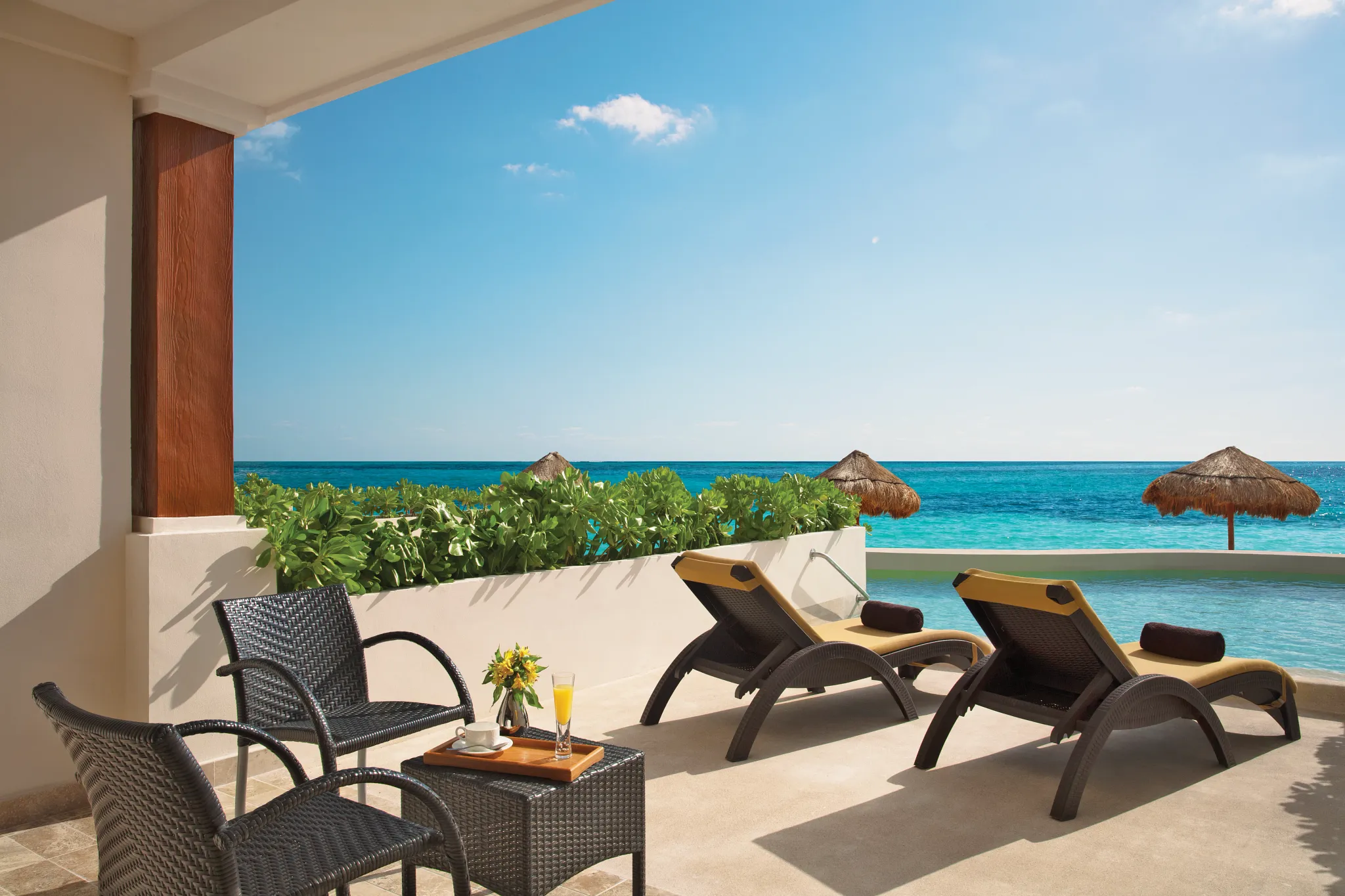 Private swim-out terrace with loungers and oceanfront views at the Preferred Club Junior Suite Beach Front Swim Out.
