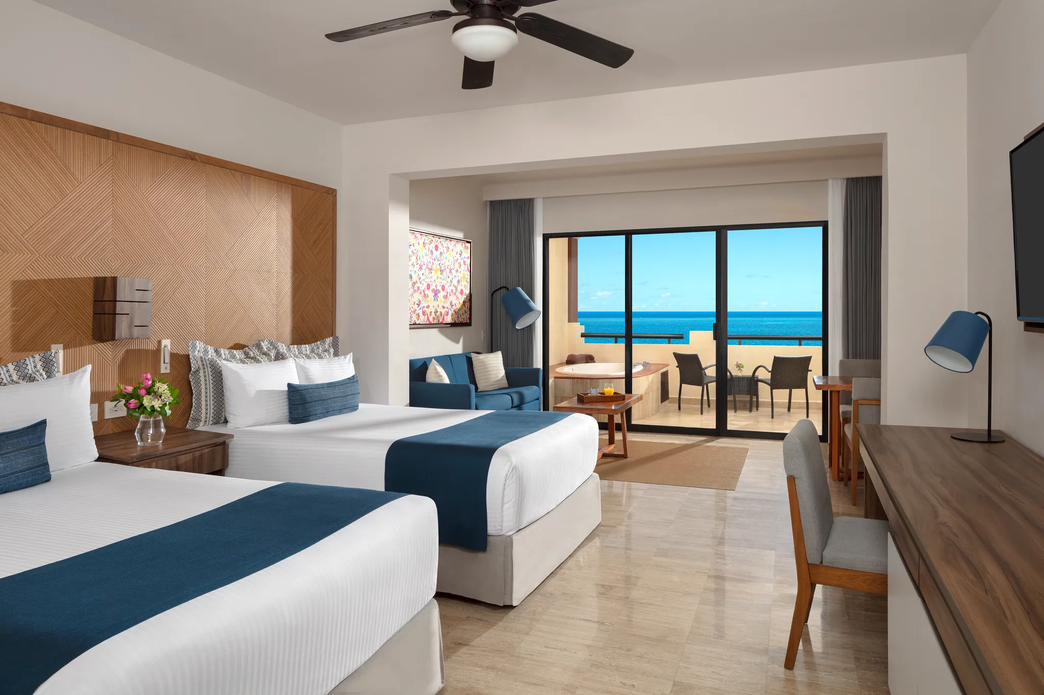 Preferred Club Junior Suite Ocean Front with double beds, ocean-view terrace, and hot tub at Dreams Sapphire Resort & Spa.