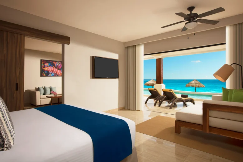 Preferred Club Master Suite Beach Front Swim Out bedroom with king-size bed and private swim-out terrace at Dreams Sapphire Resort & Spa.