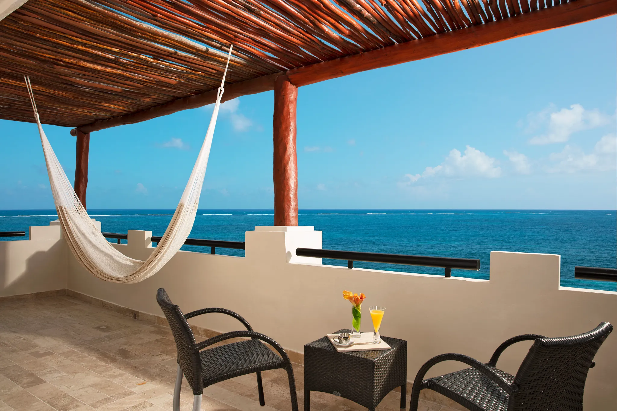 Private oceanfront balcony with hammock and Caribbean Sea views at the Preferred Club Master Suite Ocean Front.