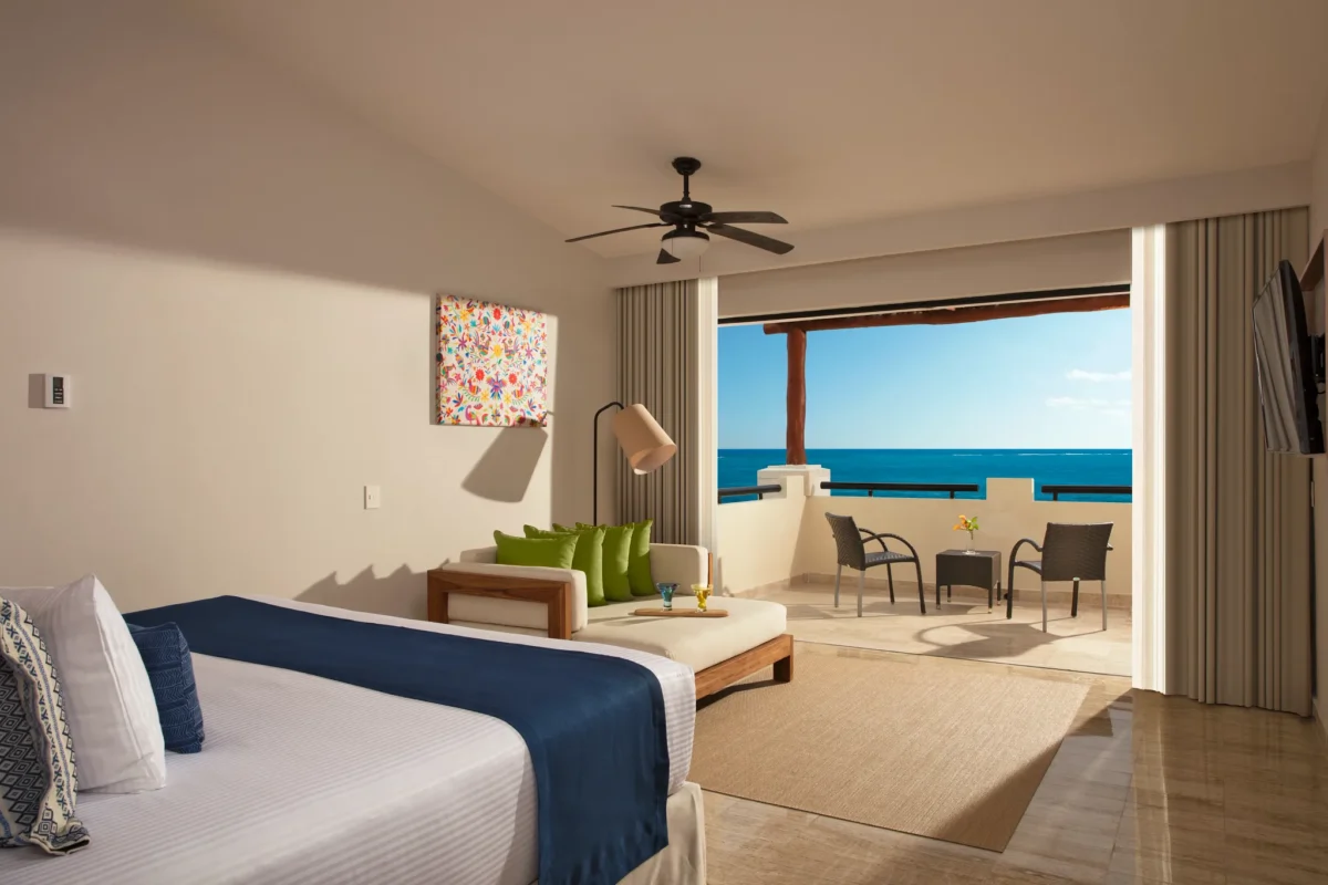 Preferred Club Master Suite Ocean Front bedroom with king-size bed and ocean-view balcony at Dreams Sapphire Resort & Spa.