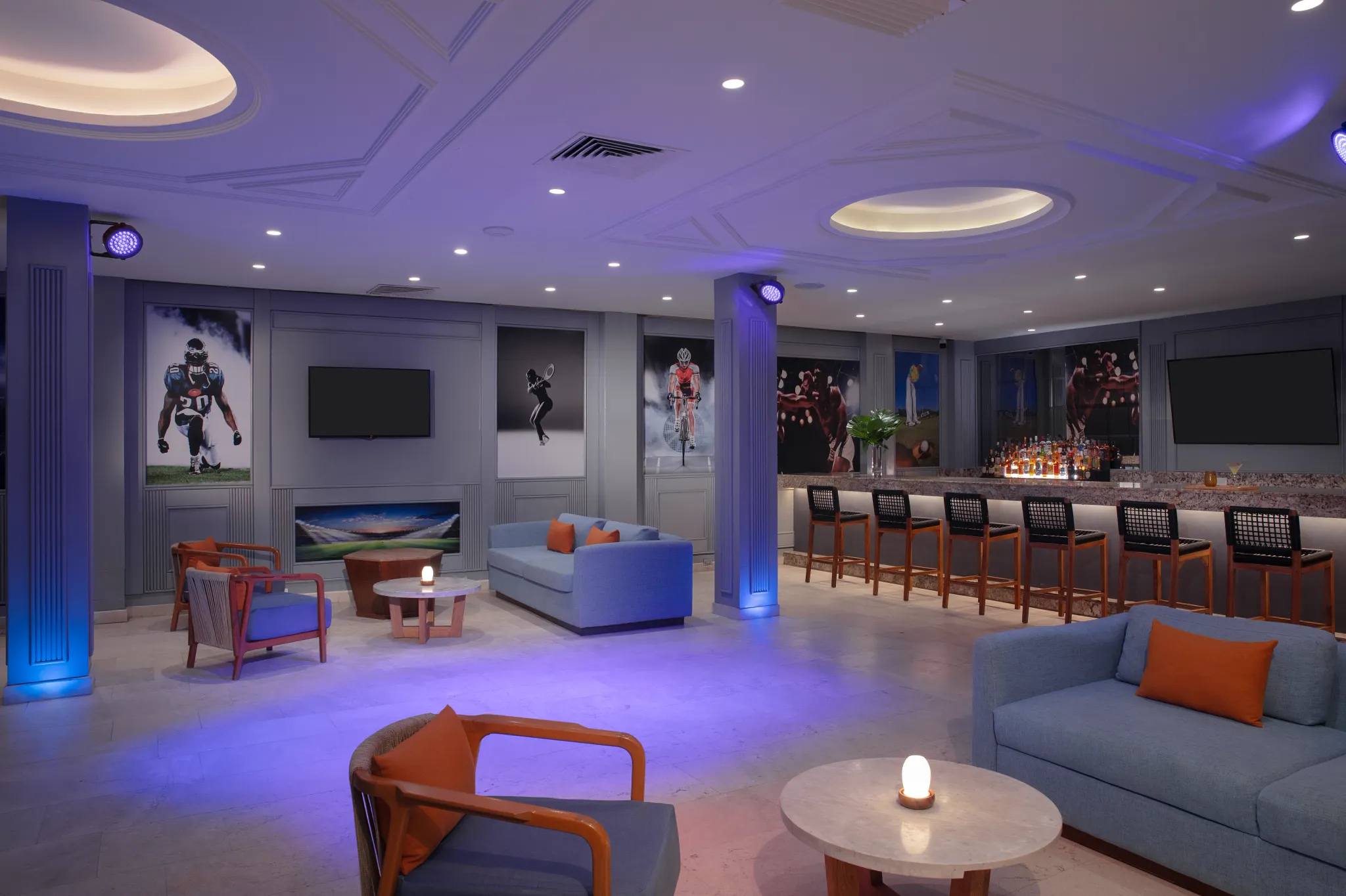 Scores Sports Bar at Dreams Sapphire Resort & Spa featuring large-screen TVs, comfortable lounge seating, and a lively atmosphere for watching live sports.