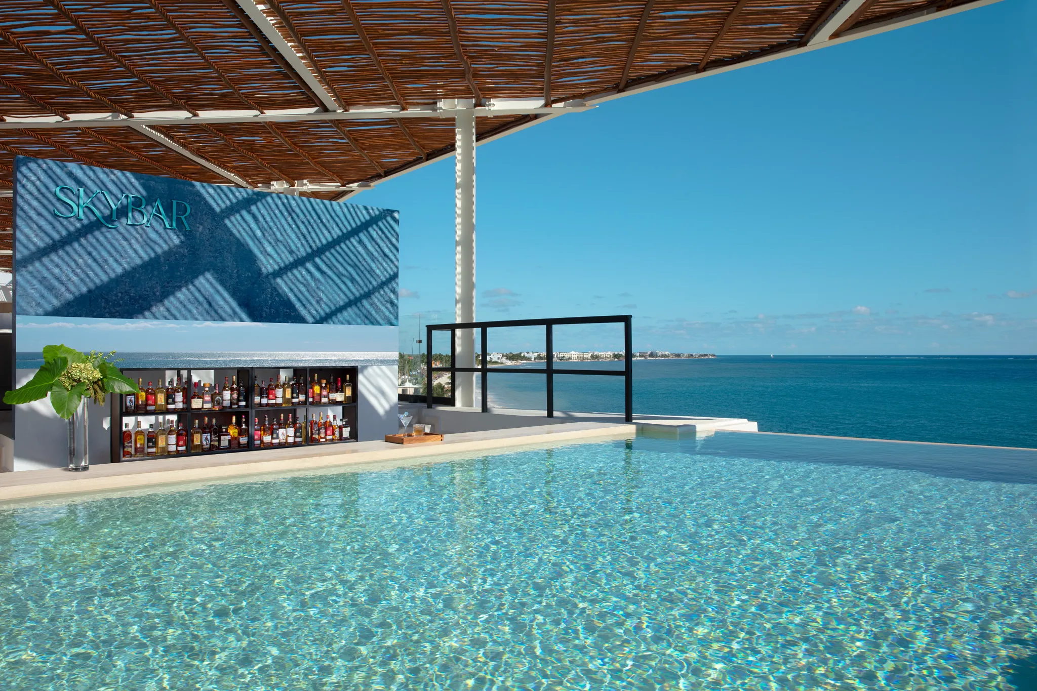Sky Bar at Dreams Sapphire Resort & Spa featuring a stylish rooftop lounge, handcrafted cocktails, and panoramic views of the Caribbean coastline.