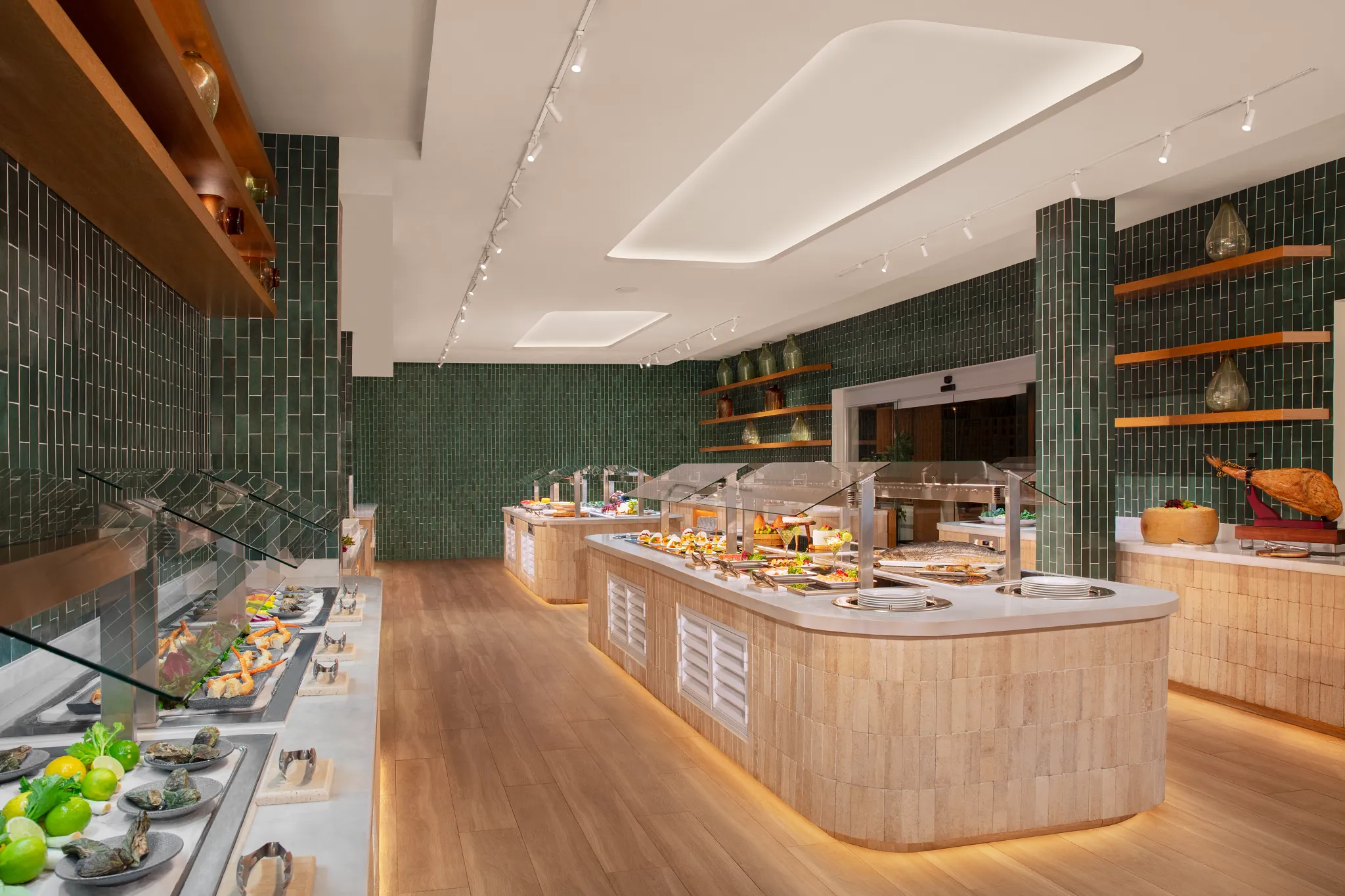 World Café at Dreams Sapphire Resort & Spa featuring an elegant international buffet with interactive cooking stations and contemporary dining space.